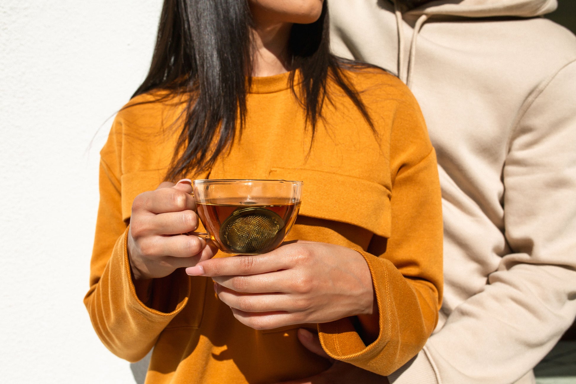 Model holding a cup of Full Spectrum Hemp and Chamomile Tea